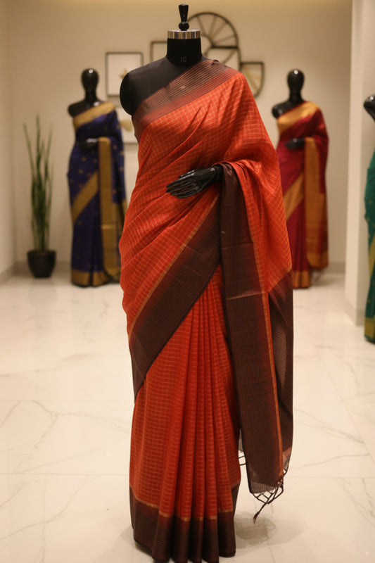 A pop orange red and coffee colored checkered saree