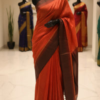 A pop orange red and coffee colored  checkered saree 
