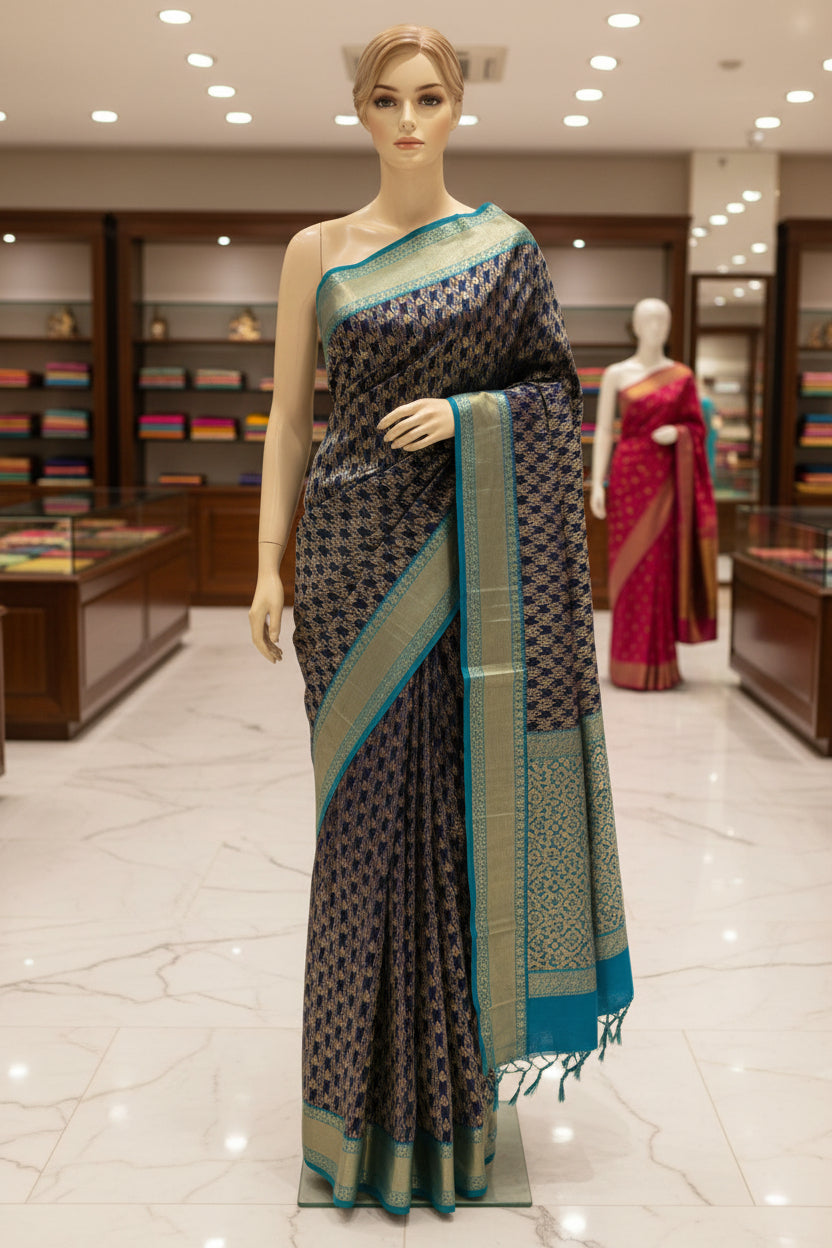 A close-up of a woven textile with a dark navy central field, repeating metallic gold geometric motifs, and bright turquoise-blue border sections on both sides.