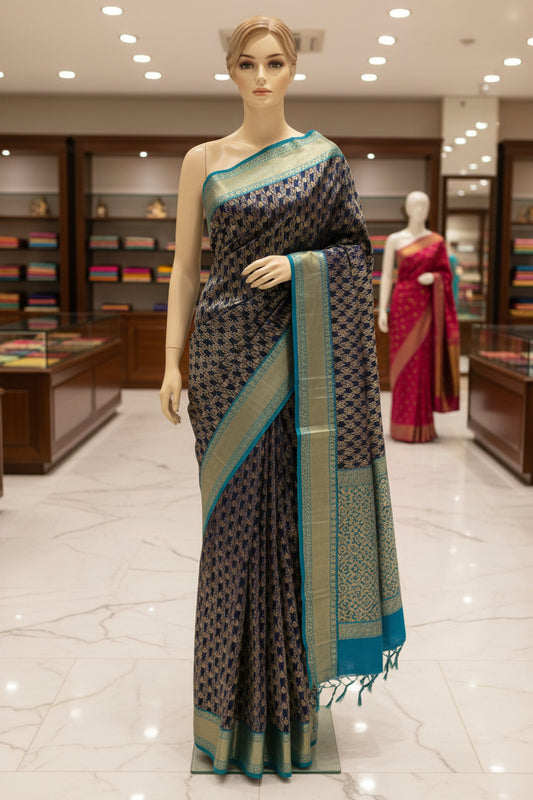 A close-up of a woven textile with a dark navy central field, repeating metallic gold geometric motifs, and bright turquoise-blue border sections on both sides.